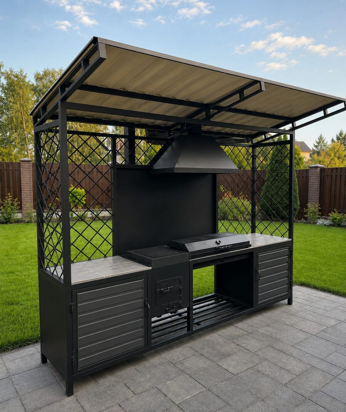 Black metal outdoor BBQ island with built-in grill and roof on a stone patio.